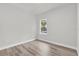 Neutral bedroom with a window providing natural light and wood-look flooring at 15443 Sw 21St Ct, Ocala, FL 34473