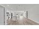 Open-concept living space featuring luxury vinyl flooring, island, and natural light at 15443 Sw 21St Ct, Ocala, FL 34473