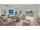 Bright living room with neutral decor, plush seating, and sliding glass doors to the backyard at 15443 Sw 21St Ct, Ocala, FL 34473