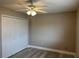 Bedroom featuring wood-look floors, ceiling fan, and double door closet at 155 N Pearl Lake Cswy # 104, Altamonte Springs, FL 32714