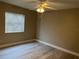 Bedroom with wood-look floors, ceiling fan and window with blinds at 155 N Pearl Lake Cswy # 104, Altamonte Springs, FL 32714
