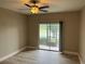 Living room featuring wood-look floors, ceiling fan, and sliding glass doors to patio at 155 N Pearl Lake Cswy # 104, Altamonte Springs, FL 32714