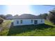 Backyard view of a single-Gathering home, with a well-kept lawn and a functional exterior design, ideal for outdoor enjoyment at 16367 Sw 17Th Terrace Rd, Ocala, FL 34473