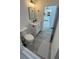 Cozy bathroom with modern fixtures and wood look floors, adjacent to a well-lit kitchen at 16367 Sw 17Th Terrace Rd, Ocala, FL 34473