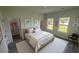 Bright bedroom with ample natural light, a walk-in closet, and modern decor for a comfortable retreat at 16367 Sw 17Th Terrace Rd, Ocala, FL 34473