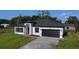 Beautifully landscaped single-Gathering home features a black two-car garage and a welcoming entrance, enhancing its appeal at 16367 Sw 17Th Terrace Rd, Ocala, FL 34473