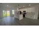 Bright, open kitchen with a large island, stainless steel appliances, and sleek white cabinets, perfect for modern living at 16367 Sw 17Th Terrace Rd, Ocala, FL 34473