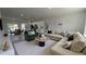 Open-concept living room featuring a modern kitchen, dining area, and comfortable seating with neutral decor at 16367 Sw 17Th Terrace Rd, Ocala, FL 34473