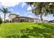 Expansive backyard with a screened-in patio and view of neighboring homes at 16761 Broadwater Ave, Winter Garden, FL 34787