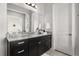 Elegant bathroom featuring granite counters, dark wood cabinetry, and modern fixtures, offering ample storage at 16761 Broadwater Ave, Winter Garden, FL 34787