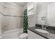 Bathroom with a tub, granite vanity, and modern gray tile at 16761 Broadwater Ave, Winter Garden, FL 34787