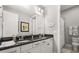 Bathroom featuring double sinks with granite countertops and modern fixtures and decor at 16761 Broadwater Ave, Winter Garden, FL 34787