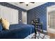Inviting bedroom with a four-poster bed, patterned wallpaper, and access to an ensuite bathroom at 16761 Broadwater Ave, Winter Garden, FL 34787
