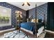 Comfortable bedroom with blue wallpaper, a four-poster bed, and a ceiling fan, creating a cozy retreat at 16761 Broadwater Ave, Winter Garden, FL 34787