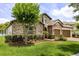 Stone-clad home with manicured lawn and three-car garage at 16761 Broadwater Ave, Winter Garden, FL 34787