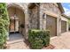Stone exterior with a gated entry and three-car garage at 16761 Broadwater Ave, Winter Garden, FL 34787