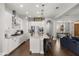 Open kitchen with white cabinets, stainless steel appliances, granite countertops, and a large center island at 16761 Broadwater Ave, Winter Garden, FL 34787