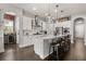 Stylish white kitchen featuring stainless appliances, stone countertops and barstool seating at 16761 Broadwater Ave, Winter Garden, FL 34787