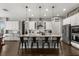 Large kitchen island with seating, stainless steel appliances, and modern finishes with custom lighting at 16761 Broadwater Ave, Winter Garden, FL 34787