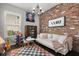 Cozy living room featuring a brick wall, modern decor, and a comfortable seating area for relaxing at 16761 Broadwater Ave, Winter Garden, FL 34787