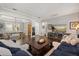 Comfortable living room with hardwood floors, ample lighting, and a view of the adjacent dining room at 16761 Broadwater Ave, Winter Garden, FL 34787
