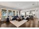 Open-concept living room with dark hardwood floors, large windows and view of the lake at 16761 Broadwater Ave, Winter Garden, FL 34787