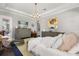Elegant bedroom with a large bed, stylish decor, and a view of a TV over a modern dresser at 16761 Broadwater Ave, Winter Garden, FL 34787