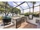 Outdoor kitchen with stainless steel grill, stone countertops, and a view of the water at 16761 Broadwater Ave, Winter Garden, FL 34787