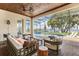 Covered patio overlooking a pool and lake featuring an outdoor seating area at 16761 Broadwater Ave, Winter Garden, FL 34787