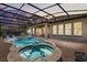 Screened-in pool and patio with a jacuzzi and outdoor seating area at 16761 Broadwater Ave, Winter Garden, FL 34787