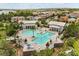 Aerial view of the community pool and clubhouse, surrounded by lush landscaping and beautiful homes at 16761 Broadwater Ave, Winter Garden, FL 34787