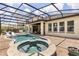 Screened-in pool and patio with a jacuzzi and outdoor seating area at 16761 Broadwater Ave, Winter Garden, FL 34787