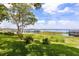 Lush green lawn with mature trees and a lake view at 16761 Broadwater Ave, Winter Garden, FL 34787