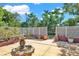Backyard featuring a stone fountain surrounded by a white lattice fence and various plants at 1705 Virginia Dr, Orlando, FL 32803
