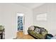 Bright bedroom with hardwood floors, floral bedding, and a seating area at 1705 Virginia Dr, Orlando, FL 32803