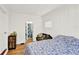 Cozy bedroom with hardwood floors, floral bedding, and a peaceful atmosphere at 1705 Virginia Dr, Orlando, FL 32803