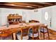 Dining room with decorative wood beamed ceilings, ceramic tile flooring, dining table, chairs, and cabinet at 1705 Virginia Dr, Orlando, FL 32803