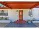 Close up view of the front entry with a decorative door, mail box and a covered porch at 1705 Virginia Dr, Orlando, FL 32803
