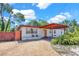Well-maintained single-story home featuring a gravel driveway and covered carport at 1705 Virginia Dr, Orlando, FL 32803