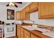 Kitchen with bright wood cabinets, ceramic tile countertops, and white appliances at 1705 Virginia Dr, Orlando, FL 32803