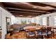 Open-concept living and dining area featuring a wood-beamed ceiling and large windows at 1705 Virginia Dr, Orlando, FL 32803