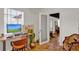 Bright home office with wood floors, modern desk, and door leading to entryway at 1705 Virginia Dr, Orlando, FL 32803