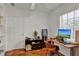 Bright home office featuring wood floors, a desk, and a storage unit with open shelving at 1705 Virginia Dr, Orlando, FL 32803