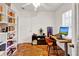 Bright home office featuring a built in bookshelf, wood floors, and a modern desk at 1705 Virginia Dr, Orlando, FL 32803