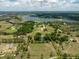 Aerial view of estate with a pool, surrounded by greenery and adjacent to a lake with additional homesites at 17524 Seidner Rd, Winter Garden, FL 34787