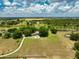 Expansive aerial view of a sprawling estate with lush green fields, mature trees, and a winding driveway at 17524 Seidner Rd, Winter Garden, FL 34787