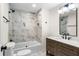 Elegant bathroom with marble wall, tub, and modern vanity at 17524 Seidner Rd, Winter Garden, FL 34787