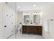 Well-appointed bathroom with double sinks, wood cabinetry, and ample lighting at 17524 Seidner Rd, Winter Garden, FL 34787