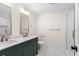 Updated bathroom with dual sinks, green cabinets, and marble floors at 17524 Seidner Rd, Winter Garden, FL 34787