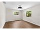 Cozy bedroom with wood floors, neutral walls, and a modern ceiling fan at 17524 Seidner Rd, Winter Garden, FL 34787
